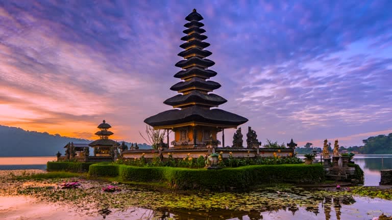 Pura Ulun Danu Bratan temple reflected on a Bali lake at sunset